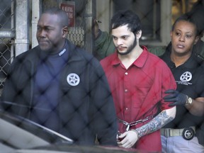 FILE - In this Jan. 30, 2017, file photo, Esteban Santiago, center, is led from the Broward County jail for an arraignment in federal court in Fort Lauderdale, Fla. Federal prosecutors on Monday, May 21, 2018, filed court documents in which agrees to plead guilty to a Florida airport shooting rampage that killed five people and wounded six last year. The agreement filed Monday says that 28-year-old Santiago will plead guilty to 11 of the 22 counts against him. Prosecutors reached a deal with Santiago's defense lawyers not to seek the death penalty in exchange for the guilty plea. Instead, Santiago would serve a life prison sentence.