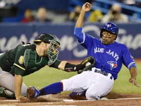 Curtis Granderson of the Toronto Blue Jays is tagged out at the plate by Oakland A's catcher Josh Phegley during MLB action Friday at Rogers Centre. The A's were 3-1 winners.