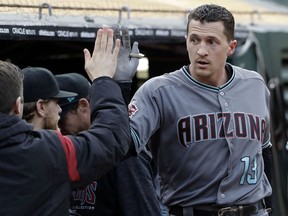 Arizona Diamondbacks' Nick Ahmed receives a high-five in the dugout after hitting a solo home run against the Oakland Athletics during the first inning of a baseball game Friday, May 25, 2018, in Oakland, Calif.
