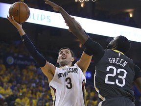 New Orleans Pelicans' Nikola Mirotic, left, shoots against Golden State Warriors' Draymond Green (23) in the first half in Game 2 of a second-round NBA basketball playoff series Tuesday, May 1, 2018, in Oakland, Calif.