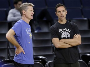 Golden State Warriors head coach Steve Kerr, left, talks to Steve Nash during an NBA basketball practice, Wednesday, May 30, 2018, in Oakland, Calif. The Warriors face the Cleveland Cavaliers in Game 1 of the NBA Finals on Thursday in Oakland.
