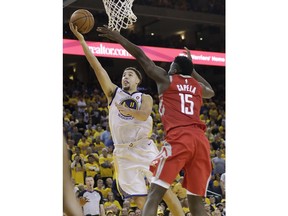 Golden State Warriors guard Klay Thompson (11) shoots against Houston Rockets center Clint Capela (15) during the second half of Game 6 of the NBA basketball Western Conference Finals in Oakland, Calif., Saturday, May 26, 2018.