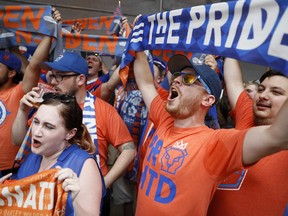 Fans cheer before speakers take the stage at an event to announce the addition of FC Cincinnati to Major League Soccer, Tuesday, May 29, 2018, at Rhinegeist Brewery in Cincinnati. FC Cincinnati has set attendance records in its three seasons in the United Soccer League and will get a soccer-only stadium in two years. The announcement on Tuesday brings MLS a step closer to its goal of a 28-team league. The latest round of expansion will bring it to 26 teams.
