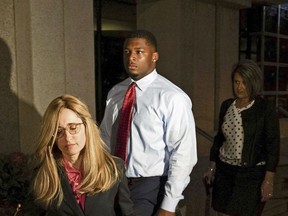FILE – In this Sept. 14, 2017, file photo, Ma'lik Richmond, center, of Steubenville, Ohio, and his attorney Susan Stone, left, walk out of U.S. District Court in Youngstown, Ohio. An Ohio judge ordered Friday, May 11, 2018, that Richmond, a former high school football player convicted in 2013 of raping a girl from West Virginia, be removed from Ohio's sex offender registry for juveniles, as allowed by law.