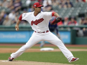Cleveland Indians starting pitcher Carlos Carrasco delivers in the first inning in the first baseball game of a doubleheader against the Toronto Blue Jays, Thursday, May 3, 2018, in Cleveland.