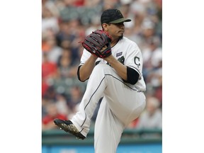 Cleveland Indians starting pitcher Carlos Carrasco winds up during the first inning of the team's baseball game against the Houston Astros, Saturday, May 26, 2018, in Cleveland.