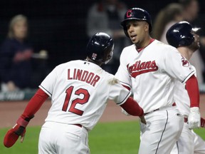 Cleveland Indians' Michael Brantley, right, is congratulated by Francisco Lindor after Brantley hit a grand slam during the fourth inning of a baseball game against the Kansas City Royals, Friday, May 11, 2018, in Cleveland. Lindor scored on the homer.