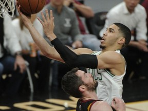 Boston Celtics' Jayson Tatum (0) drives to the basket against Cleveland Cavaliers' Kevin Love (0) during the first half of Game 6 of the NBA basketball Eastern Conference finals Friday, May 25, 2018, in Cleveland.