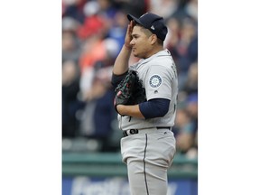 Seattle Mariners starting pitcher Erasmo Ramirez wipes his forehead as he waits for Cleveland Indians' Michael Brantley to run the bases on a solo home run during the first inning of a baseball game Friday, April 27, 2018, in Cleveland.