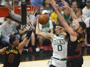 Boston Celtics' Jayson Tatum (0) drives to the basket against Cleveland Cavaliers' Larry Nance Jr. (22) and Jordan Clarkson (8) during the second half of Game 6 of the NBA basketball Eastern Conference finals Friday, May 25, 2018, in Cleveland.
