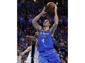 FILE - In this March 10, 2018 file photo, Oklahoma City Thunder forward Nick Collison (4) shoots in the second half of an NBA basketball game against the San Antonio Spurs in Oklahoma City. Collison announced Thursday, May 10, 2018, that  is retiring after 15 years with the Thunder.