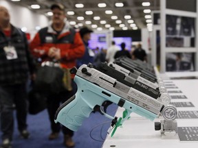 Handguns are on display at the NRA convention in Dallas, Friday, May 4, 2018. Oklahoma's Republican Gov. Mary Fallin vetoed a bill late Friday that would have authorized adults to carry firearms without a permit or training, dealing a rare defeat to the National Rifle Association in a conservative state.