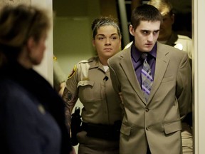 In this April 18, 2018 photo, Michael Bever arrives at the Tulsa County Courthouse for his murder trial in Tulsa, Okla. An investigator testified that Bever, the younger of two brothers accused of fatally stabbing their parents and three siblings in their Oklahoma home, denied killing anyone.