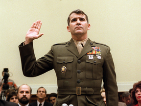 Lieutenant-Colonel Oliver North is sworn in before the House Foreign Affairs Committee hearing in Washington, DC. on on Dec. 9, 1986.