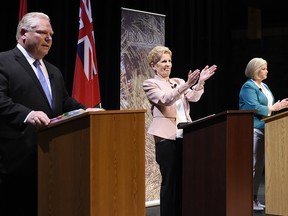 Ontario Progressive Conservative Leader Doug Ford, left to right, Ontario Liberal Leader Kathleen Wynne and Ontario NDP Leader Andrea Horwath applaud as they finish taking part in the second of three leaders' debate in Parry Sound, Ont., on Friday, May 11, 2018.