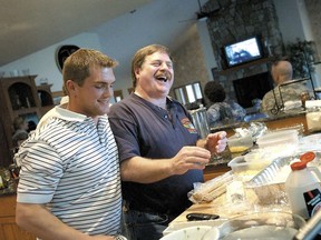 FILE - In this April 18, 2006 file photo, Capt. Rick Quashnick, right, shares a laugh with boat engineer Blake Painter, left, as family and close friends gather at Quashnick's Warrenton, Ore., house to watch the Discovery Channel series "The Deadliest Catch." Painter, an Astoria fisherman featured on the television series 'The Deadliest Catch,' has died. He was 38. Clatsop County Sheriff Tom Bergin confirmed Tuesday, May 29, 2018, that Painter had been found in his home May 25 by a friend who visited after being unable to reach him.