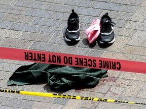 CORRECTS TO MOTORIST-Clothing is strewn on the sidewalk at a scene where pedestrians were hit by a motorist in Portland, Ore., Friday, May 25, 2018. Police say three women have been injured in a hit-and-run crash near Portland State University.