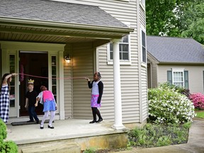 From left, Arielle Lichterman, 9,   Julian Lichterman, Laila Widgeon, and Nahla Widgeon  play limbo during a television viewing party of the royal wedding of Meghan Markle and Prince Harry,  Saturday, May 18, 2018, at the Armstrong-Turner residence in Burlington, N.J.  The ceremony married the pomp and circumstance of Britain's most sacred institution with elements of black culture, drawing viewers not normally drawn to the spectacle of the monarchy.