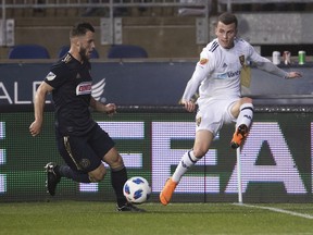Real Salt Lake's Brooks Lennon, right, passes the ball away from Philadelphia Union's Keegan Rosenberry during the first half of an MLS soccer match Saturday, May 19, 2018, in Chester, Pa.