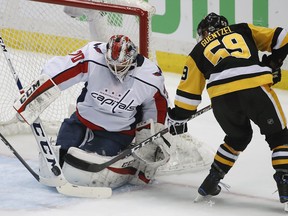 Washington Capitals goaltender Braden Holtby (70) stops a shot by Pittsburgh Penguins' Jake Guentzel (59) during the first period in Game 4 of an NHL second-round hockey playoff series in Pittsburgh, Thursday, May 3, 2018.