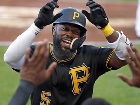 Pittsburgh Pirates' Josh Harrison returns to the dugout after hitting a solo home run off Chicago Cubs starting pitcher Kyle Hendricks during the first inning of a baseball game in Pittsburgh, Wednesday, May 30, 2018.
