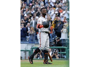 San Francisco Giants' Andrew McCutchen acknowledges fans during a tribute to his years with the Pittsburgh Pirates, before his first at-bat in the first inning of a baseball game in Pittsburgh, Friday, May 11, 2018. Pittsburgh Pirates starting pitcher Jameson Taillon struck out McCutchen.