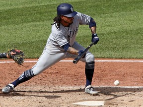 San Diego Padres' Freddy Galvis drives in a run with a bunt-single off Pittsburgh Pirates relief pitcher Felipe Vazquez in the ninth inning of a baseball game in Pittsburgh, Sunday, May 20, 2018.