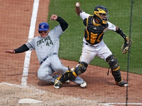 Pittsburgh Pirates catcher Elias Diaz, right, throws to first after getting the force-out at home plate on Chicago Cubs' Anthony Rizzo (44) on a fielder's choice in the eighth inning of a baseball game in Pittsburgh, Monday, May 28, 2018. Diaz's errant throw to first allowed two runs to score.