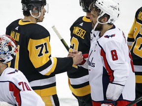 Washington Capitals' Alex Ovechkin (8) shakes hands with Pittsburgh Penguins' Evgeni Malkin (71) after the Capitals' 2-1 overtime win in Game 6 of an NHL second-round hockey playoff series in Pittsburgh, Monday, May 7, 2018. The Capitals won the series, four games to two.