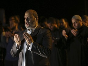 Hamas leader Khalil al-Hayya leads an evening prayer called 'tarawih' marking the first eve of the holy fasting month of Ramadan, outside the tents of the protest camp near the Israeli border east of Gaza City, Wednesday, May 16, 2018.