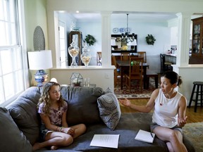 In this Thursday, May 3, 2018 photo, Sandy Nissenbaum, right, and her daughter, Nora Nissenbaum, 12, talk during an interview with The Associated Press in Wayne, Pa. The case of a suburban Philadelphia boy who was quietly allowed to return to class after being accused of making a shooting threat has thrown a spotlight on the hard decisions school authorities must make. Nora Nissenbaum who says the boy bullied her has withdrawn from class for fear of him.