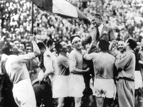 FILE - In this June 10, 1934 file photo, Italian soccer coach Vittorio Pozzo is held aloft after his team defeated Czechoslovakia 2-1 to win the World Cup final at the Fascist National Party Stadium in Rome. Italy would go on to defend the World Cup four years later in 1938 amid the drumbeat of war, with the team criticized for wearing black shirts in one of its matches.  The 21st World Cup begins on Thursday, June 14, 2018, when host Russia takes on Saudi Arabia. (AP Photo/File)