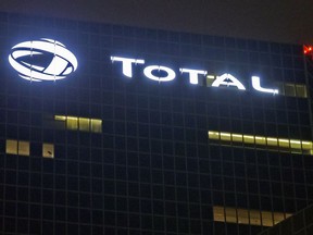 FILE - In this file photo taken on Oct.12, 2016, the logo of French oil giant Total SA is pictured at company headquarters in La Defense business district, outside Paris. French oil and gas company Total says it will not continue a multi-billion dollars project in Iran unless it is granted a waiver by U.S. authorities.
