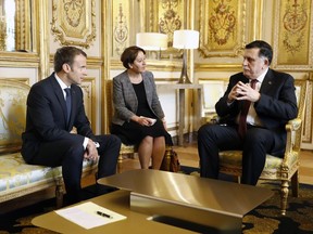 French President Emmanuel Macron, left, and Lybian Prime Minister Fayez Sarraj, head of Libya's UN-recognized government in Tripoli in the west, discuss during a meeting at the Elysee Palace for the international congress on Libya in Paris,Tuesday May 29, 2018. Libya's rival leaders are meeting in Paris to agree on a political roadmap including elections, in an effort to bring order to Libya's chaos, which is feeding Islamic militants, traffics of all kind and instability in the region.