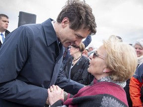 Prime Minister Justin Trudeau greets former mayor Colette Roy-Laroche during an announcement Friday, May 11, 2018 in Lac-Megantic, Que. The Quebec and federal governments will jointly fund a rail bypass in Lac-Megantic, nearly five years after 47 people were killed when a train derailed and exploded in the town.