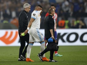 Marseille's Dimitri Payet walks off the pitch after sustaining an injury during the Europa League Final soccer match between Marseille and Atletico Madrid at the Stade de Lyon in Decines, outside Lyon, France, Wednesday, May 16, 2018.