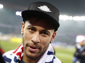 PSG player Neymar looks at the photographer during celebrations for clinching the French League One title after the soccer match between Paris Saint-Germain and Stade Rennais at the Parc des Princes stadium in Paris, Saturday May 12, 2018.