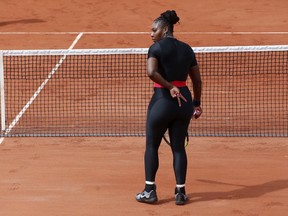 Serena Williams of the U.S. signals to her sister Venus who served against Japan's Shuko Aoyama and Miyu Kato during their first round women's doubles match of the French Open tennis tournament at the Roland Garros stadium in Paris, France, Wednesday, May 30, 2018.