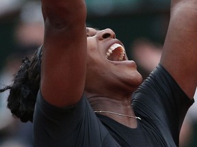 Serena Williams of the U.S. celebrates winning her second round match of the French Open tennis tournament against Australia's Ashleigh Barty in three sets, 3-6, 6-3, 6-4, at the Roland Garros stadium in Paris, France, Thursday, May 31, 2018.