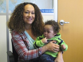 FILE - In this March 20, 2017, file photo, Rachel Dolezal poses for a photo with her son, Langston, at the bureau of The Associated Press in Spokane, Wash. Dolezal, a former NAACP leader in Washington state whose life unraveled after she was outed as a white woman pretending to be black, has been charged with welfare fraud, news station KHQ-TV reports Thursday, May 24, 2018.