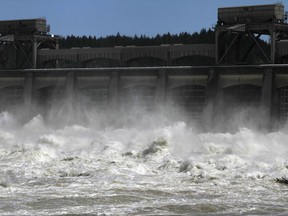 FILE - In this May 20, 2011, file photo, heavy spring runoff waters boil and churn as they pass through the spillways at Bonneville Dam near Cascade Locks, Ore. Talks are scheduled to begin Tuesday, May 29, 2018, in Washington, D.C., to modernize the document that coordinates flood control and hydropower generation in the U.S. and Canada along the Columbia River.