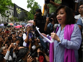 Ousted Philippine Supreme Court Chief Justice Maria Lourdes Sereno, left, reads her statement before hundreds of supporters following an en banc session by the highest court Friday, May 11, 2018 in Manila, Philippines. “Let’s continue to defend the constitution and fight wrongdoing. Let’s continue to spread the message of democracy and reason,” she told the crowd.