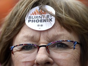 Shirley Taylor wears a "Burnt by Phoenix" sticker on her forehead during a rally against the Phoenix payroll system outside the offices of the Treasury Board of Canada in Ottawa on Wednesday, Feb. 28, 2018.