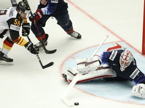 Keith Kinkaid, right, of the United States makes a save against Germany's Markus Eisenschmid, left, during the Ice Hockey World Championships group B match between United States and Germany at the Jyske Bank Boxen arena in Herning, Denmark, Monday, May 7, 2018.