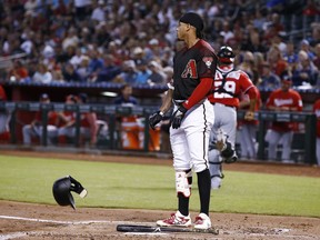 Arizona Diamondbacks shortstop Ketel Marte throws his helmet down after striking out against the Washington Nationals during the first inning of a baseball game Saturday, May 12, 2018, in Phoenix.
