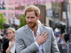 Prince Harry greets members of the public during a walkabout  outside Windsor Castle on May 18, 2018.