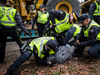 A man is tackled and handcuffed by RCMP officers at the site of a Kinder Morgan facility in Burnaby, B.C., on March 19, 2018. He was later released without being charged.