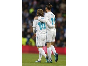 Real Madrid's Gareth Bale, right and Luka Modric embrace after Bale scored his side's 2nd goal during a Spanish La Liga soccer match between Real Madrid and Celta at the Santiago Bernabeu stadium in Madrid, Spain, Saturday, May 12, 2018.