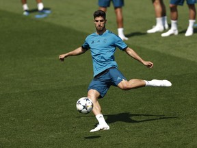 In this May 22, 2018 file photo, Real Madrid's Marco Asensio shoots the ball during a training session at the team's Veldebebas training ground in Madrid, Spain. With Spain's golden generation all but gone, it's up to a group of talented youngsters that include Marco Asensio and Francisco "Isco" Alarcon to try to take over the Spanish national team and lead La Roja back to its glory days.