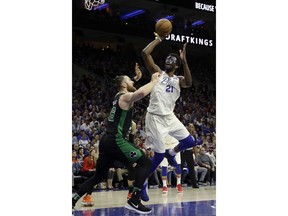 Philadelphia 76ers' Joel Embiid (21) goes up for a shot against Boston Celtics' Aron Baynes (46) during the first half of Game 3 of an NBA basketball second-round playoff series Saturday, May 5, 2018, in Philadelphia.